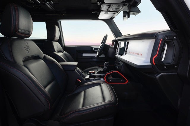 The interior includes a white instrument mid-panel with Code Orange accents for a heritage-inspired look. Credit: Ford