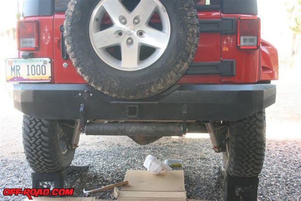 Even with the Jeep up on the ramps the exhaust pipe is barely visible, and the muffler itself is tucked up above the Bestop bumper.