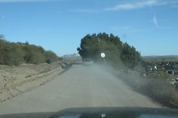 A short time later, Price Road loses the pavement and continues its course. Thats trail leader Matt Cawley ahead of us in his long-travel 4x4 Ford Explorer.