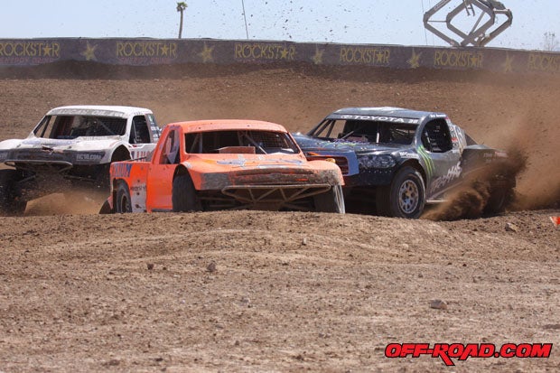 Carl Renezeder (1, left) stayed in the hunt and took advantage of Adrian Cenni (11) and Rick Huseman tangling up in this turn. 